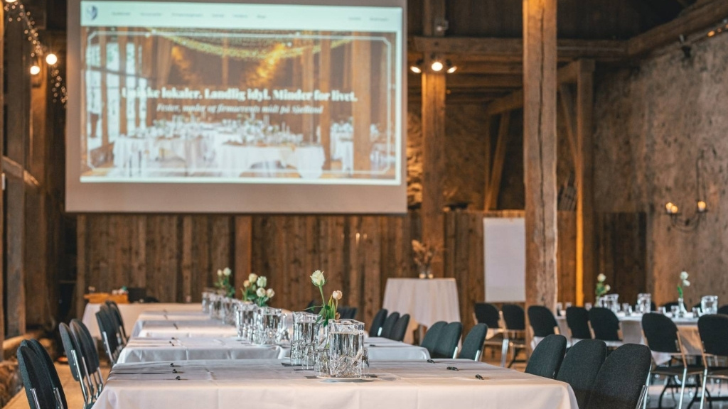 Meeting room at Sonnerupgaard Gods with long tables and rustic interior.
