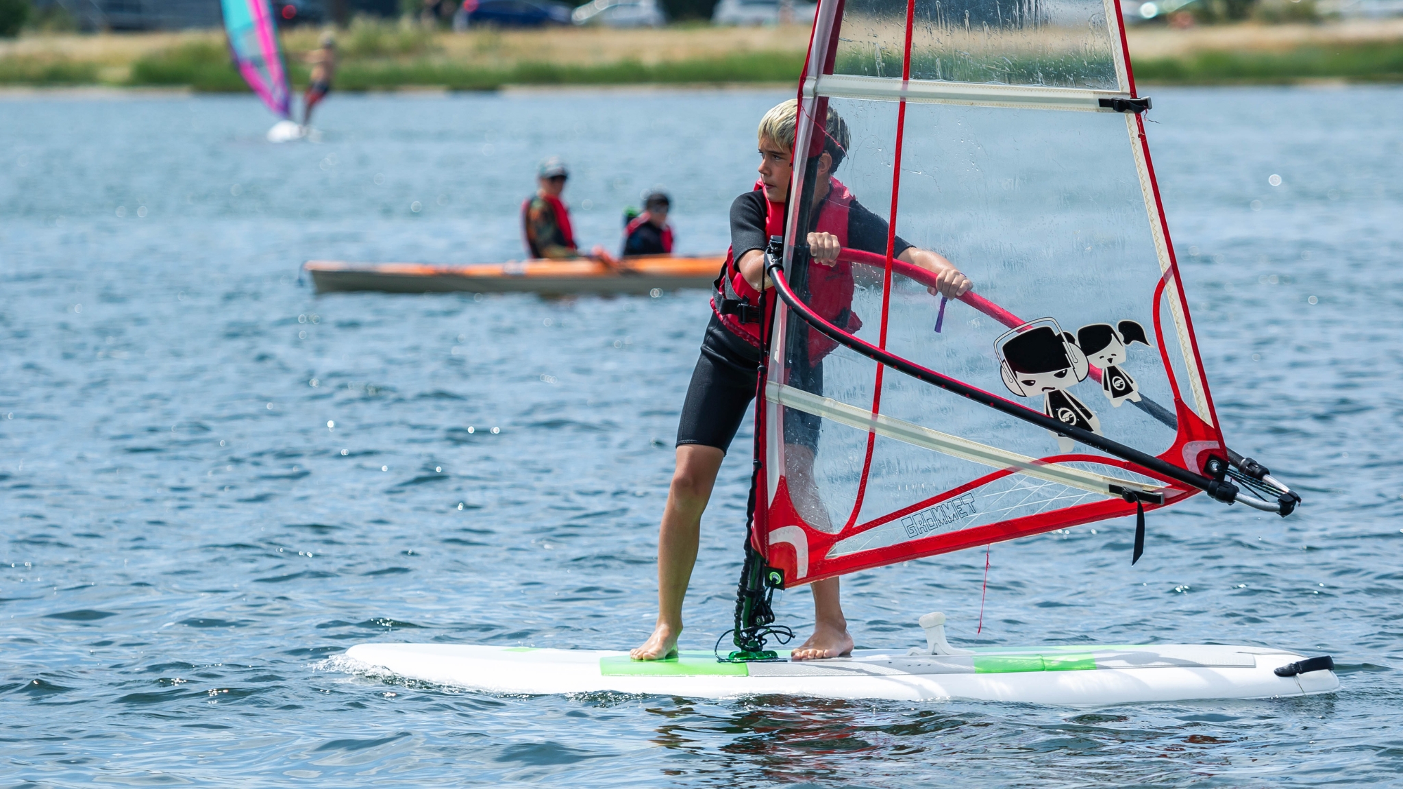 Child windsurfing on the water in Frederikssund.