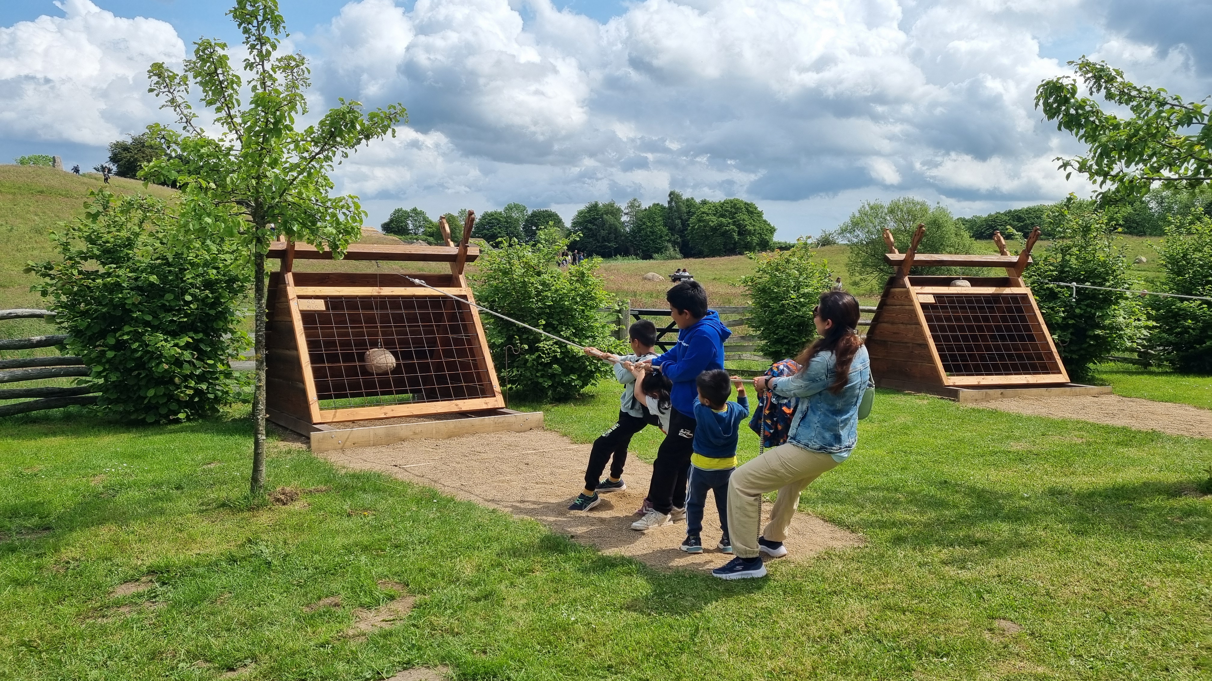 Family taking part in a historical outdoor activity at Sagnlandet Lejre.