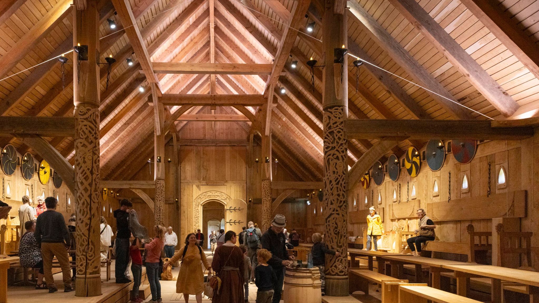Interior of the King’s Hall with visitors and historic furnishings in Sagnlandet Lejre.