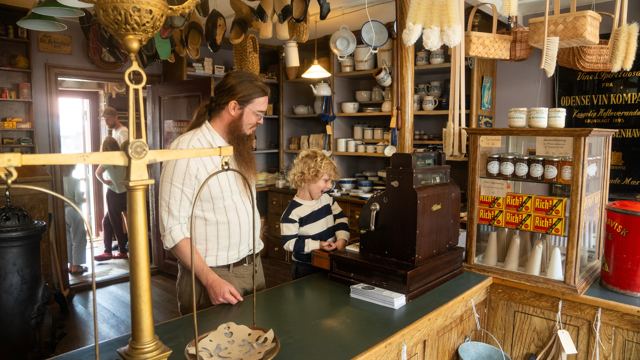 Visitors inside the historic general store at Lützhøfts Købmandsgaard.