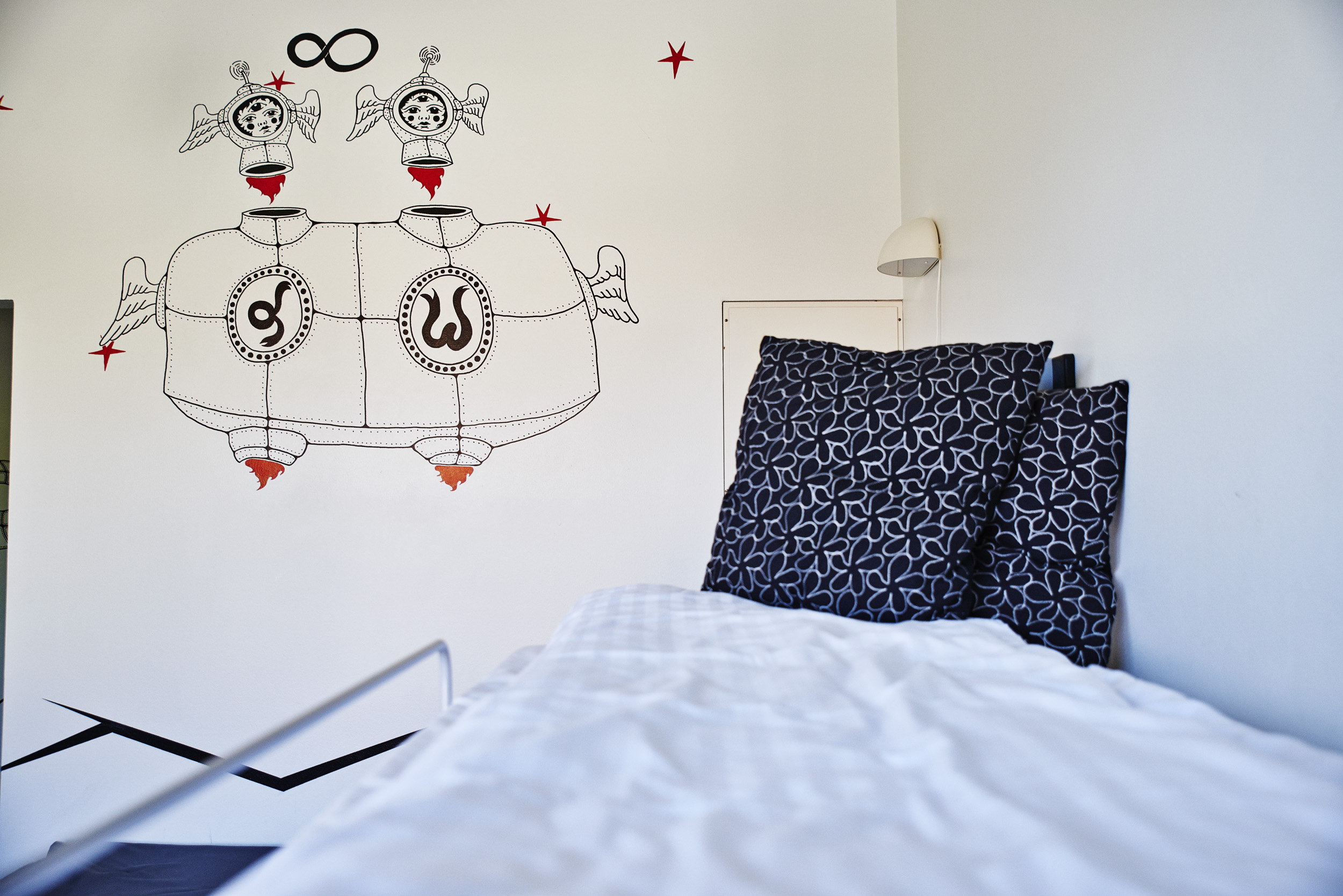 A room with a bed and wall art at Danhostel Roskilde