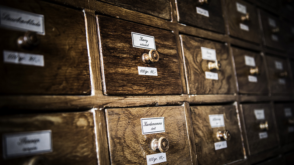 Old wooden spice drawers with handwritten labels at Lützhøft’s Old Grocer’s Shop.