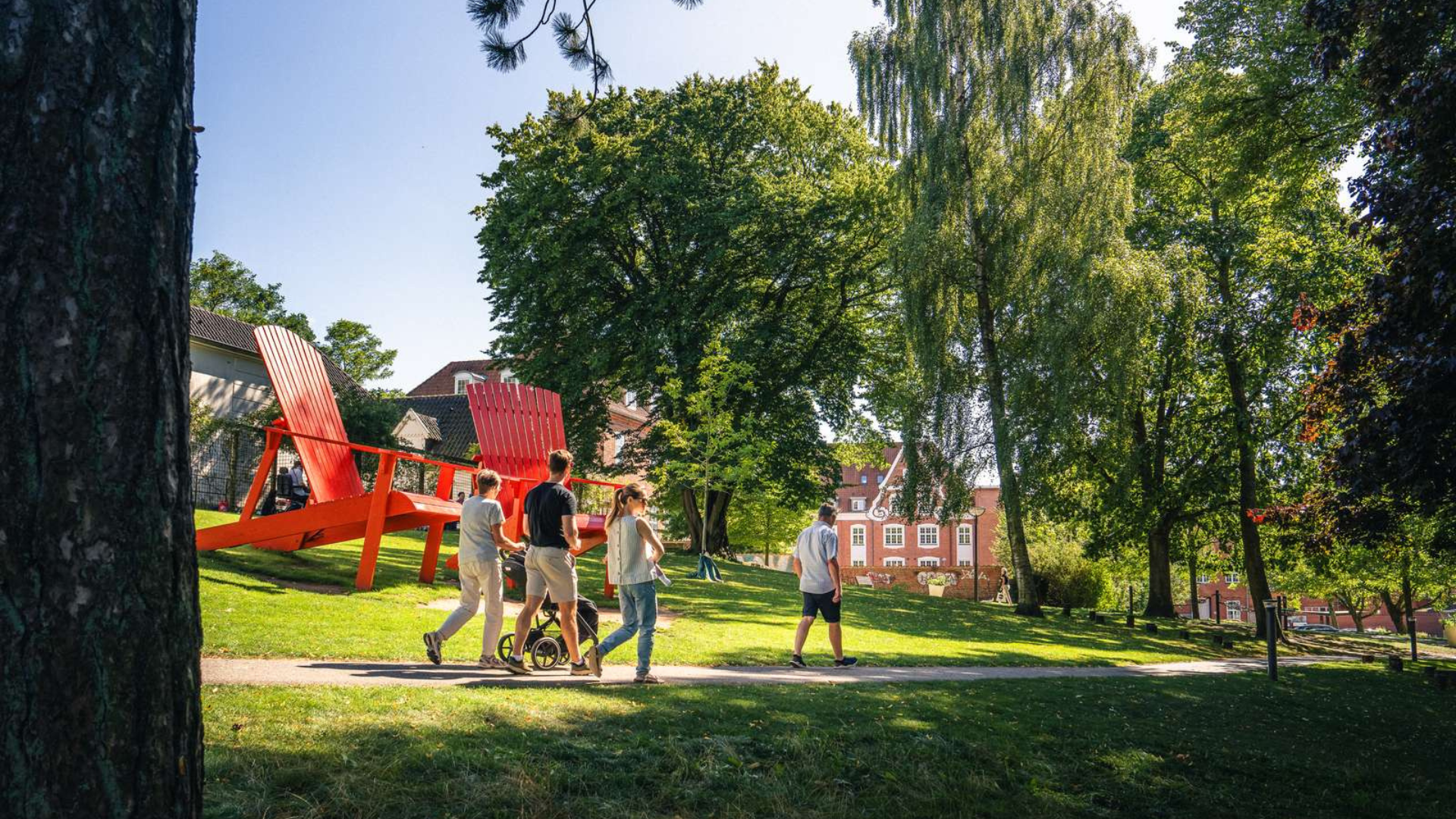 Family walking in Mariaparken on a summer day
