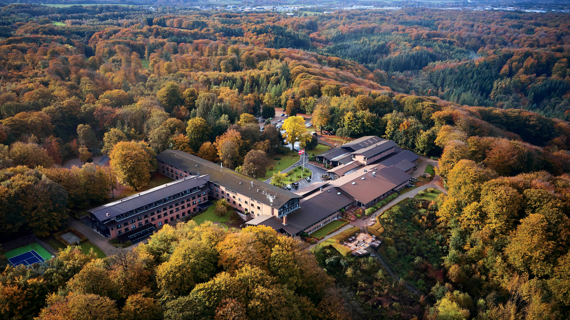 View of Munkebjerg Hotel and Munkebjerg Forest by Vejle Fjord on an autumn day