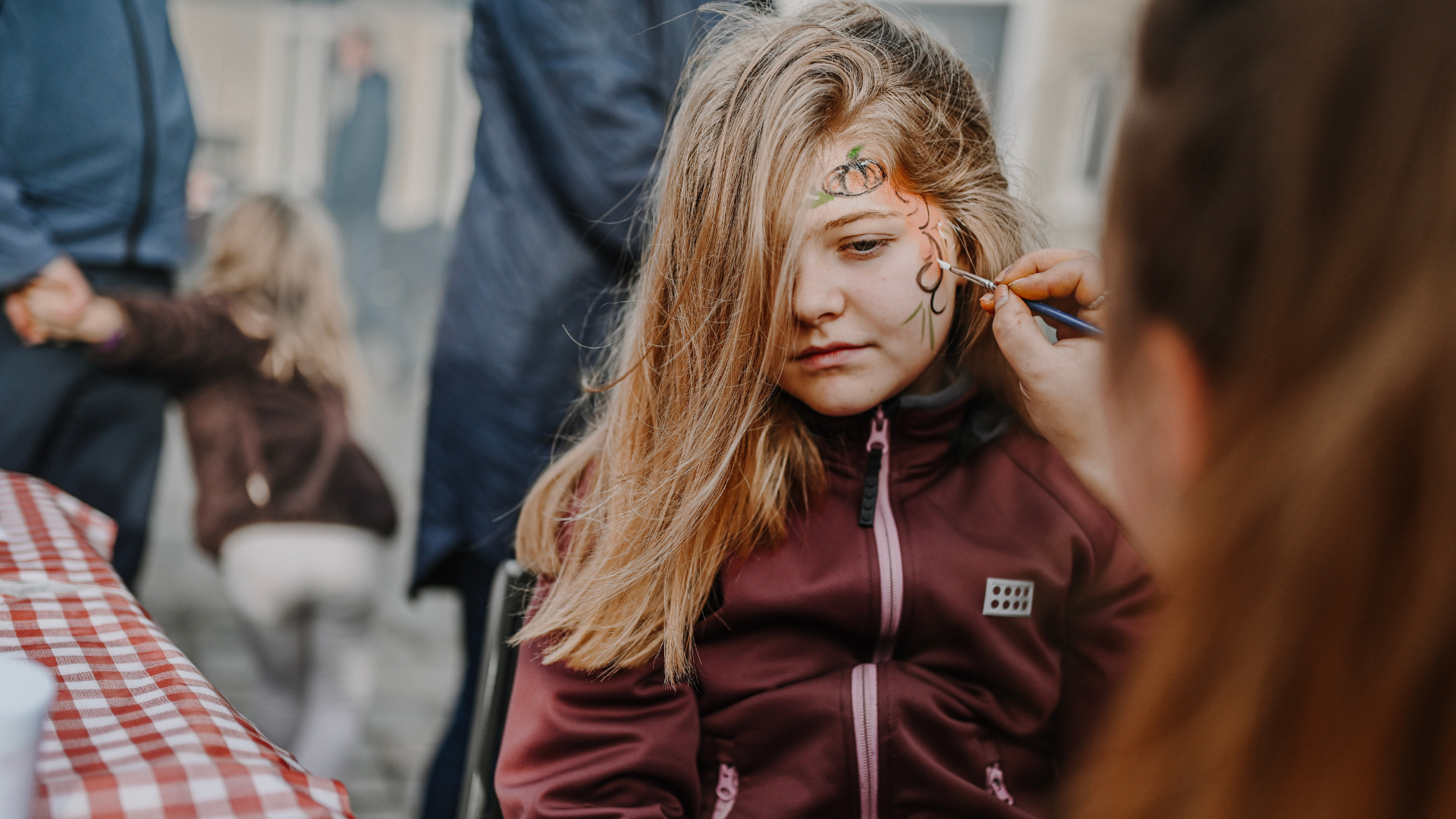 Girl getting face painted for Halloween in Vejle city centre