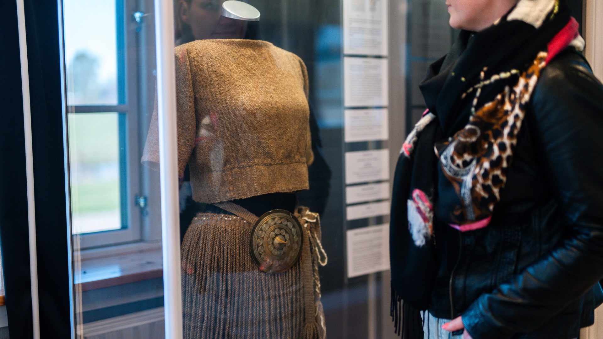 Woman looking at the Egtved Girl’s costume at Egtved Museum