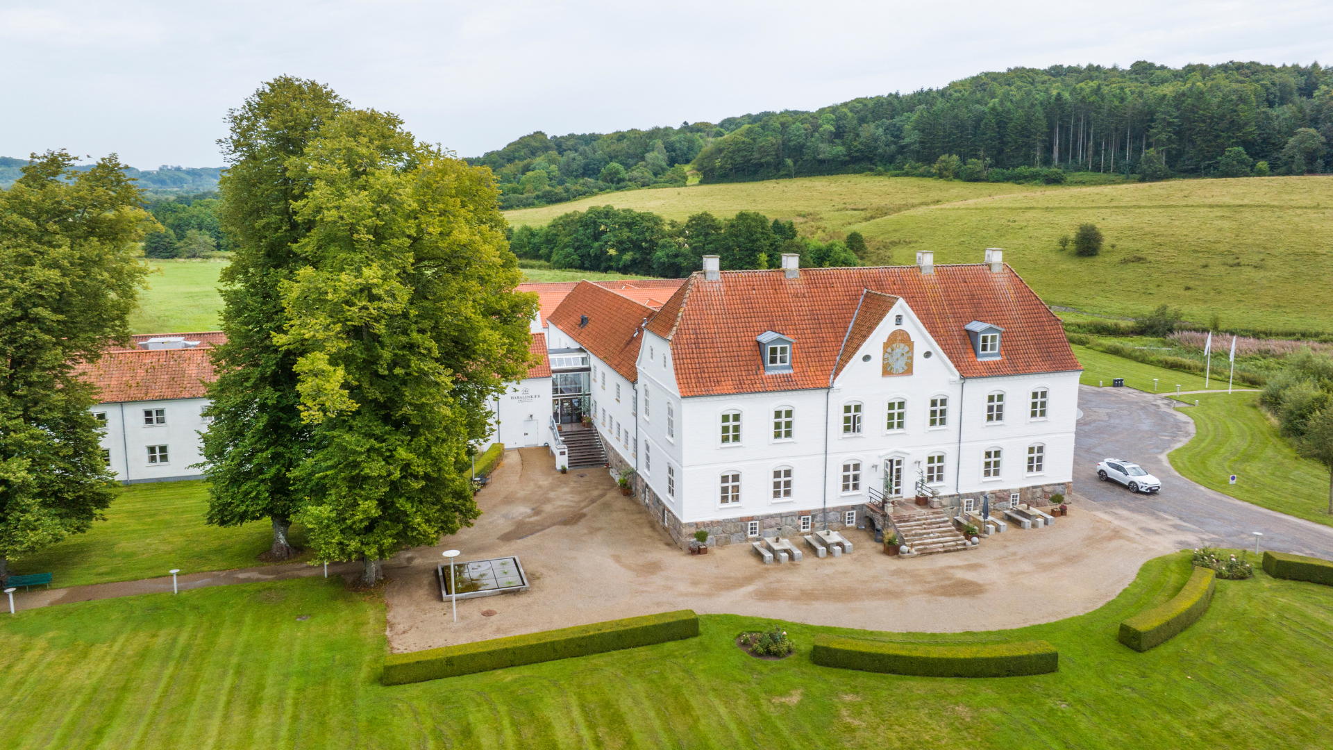View of Haraldskær Sinatur Hotel & Konference in Vejle River Valley on a summer day