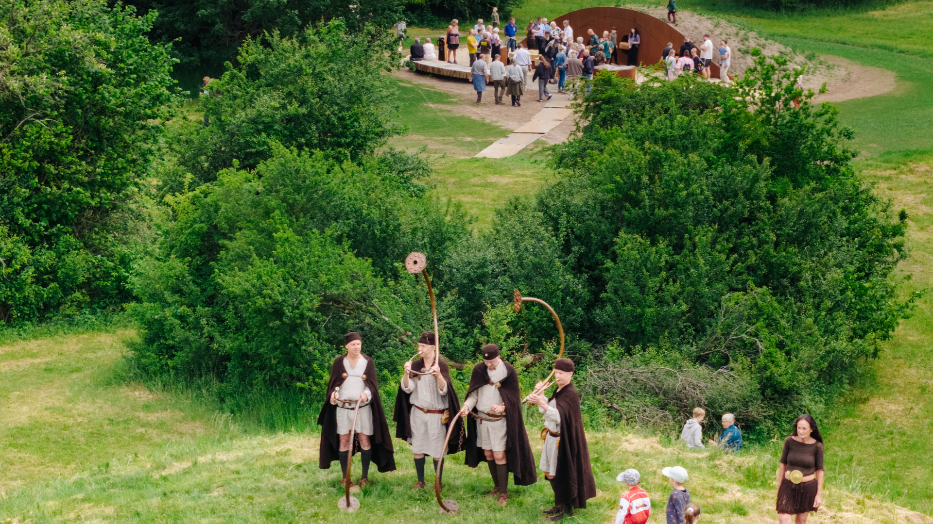 Lur players in Bronze Age clothing at the opening of Egtvedpigens Verden