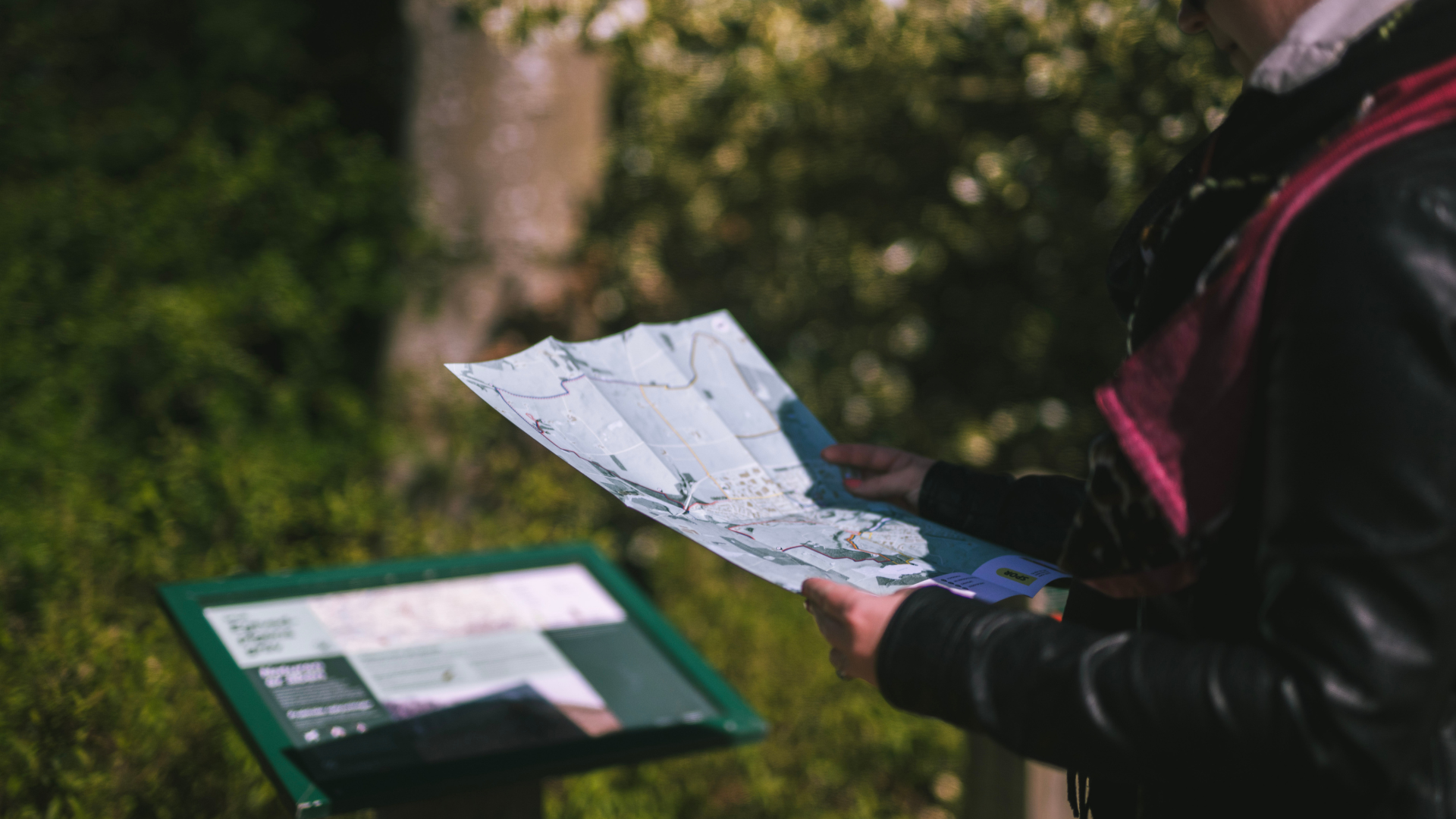 Woman looking at a map of the trails in and around Egtved