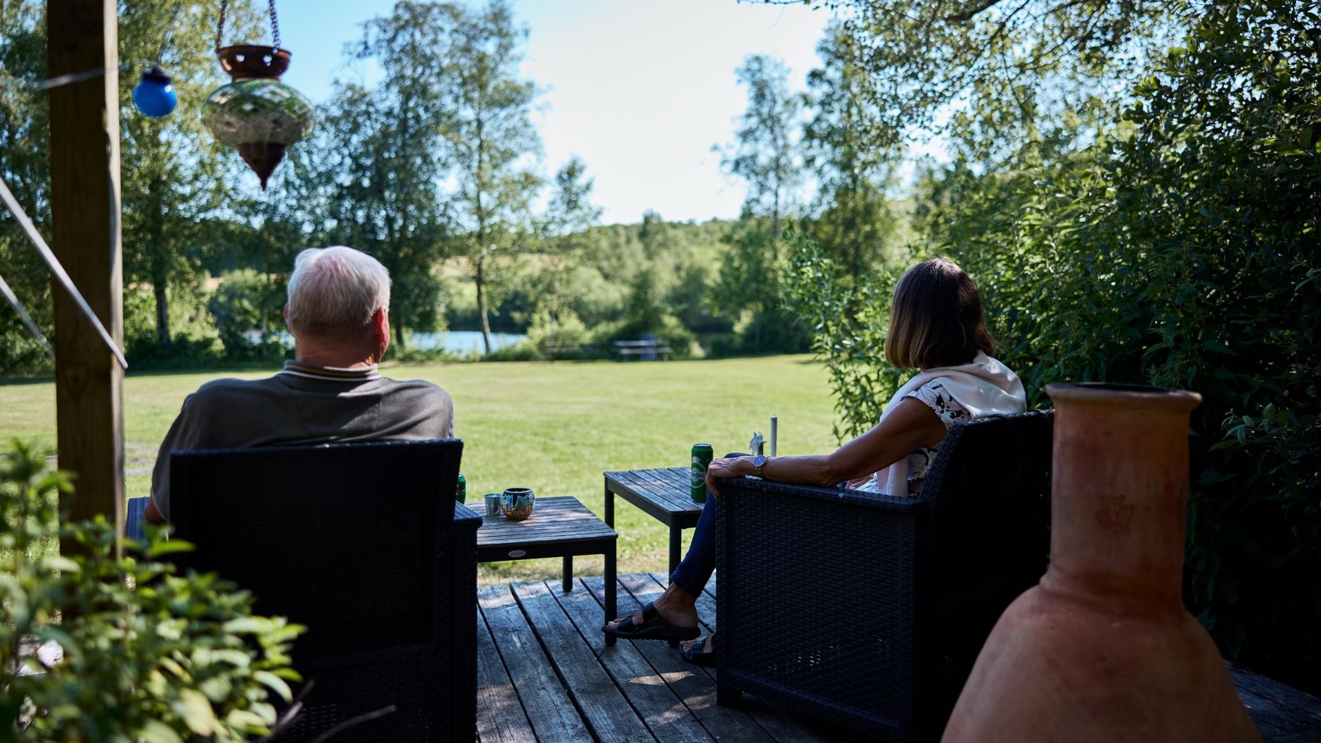 A couple enjoying the view of the lake from the glamping tent at Egtved Camping near Vejle