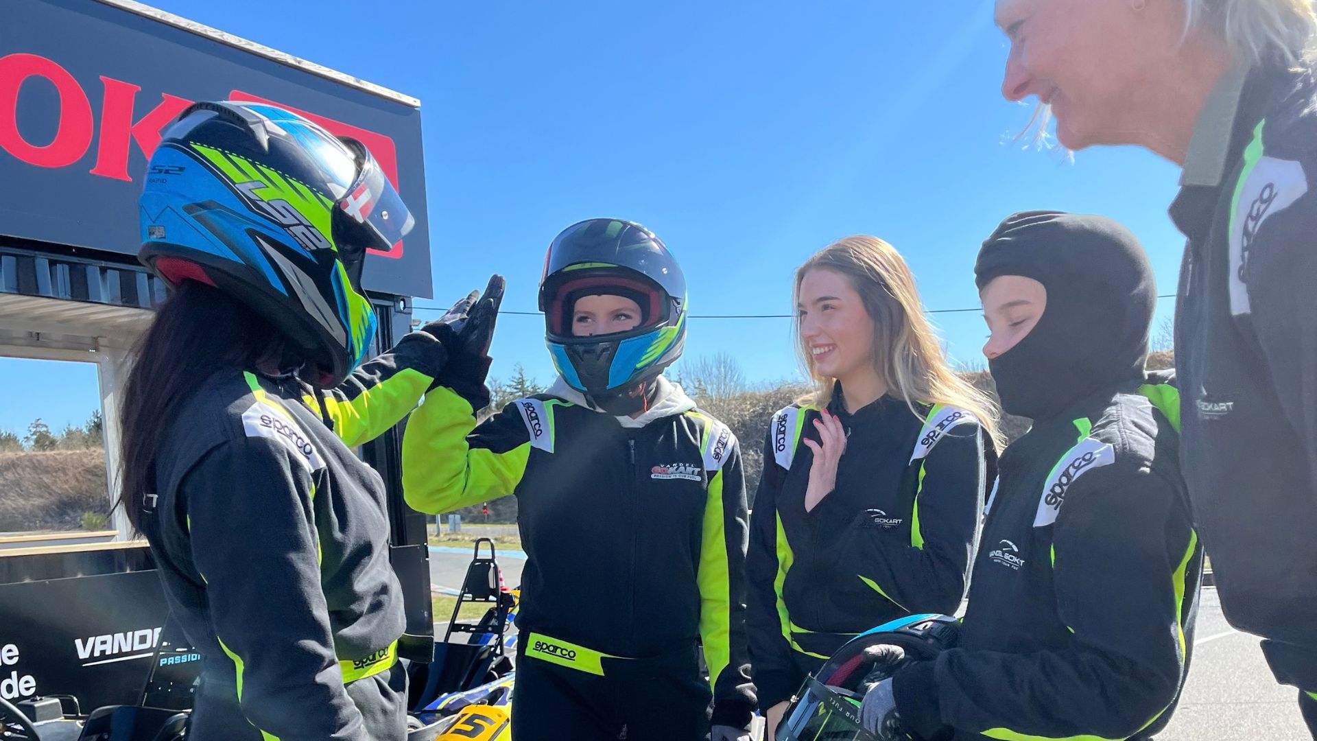 A group is wearing go-karting gear and ready to hit the track at Vandel Gokart near Vejle.