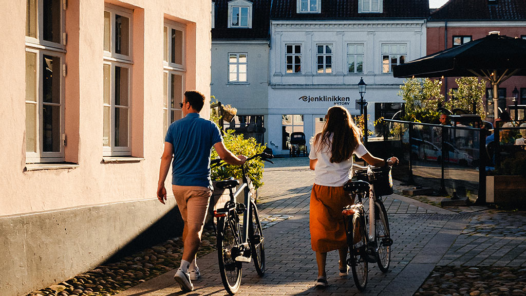 Couple with bicycle on Nytorv in Viborg