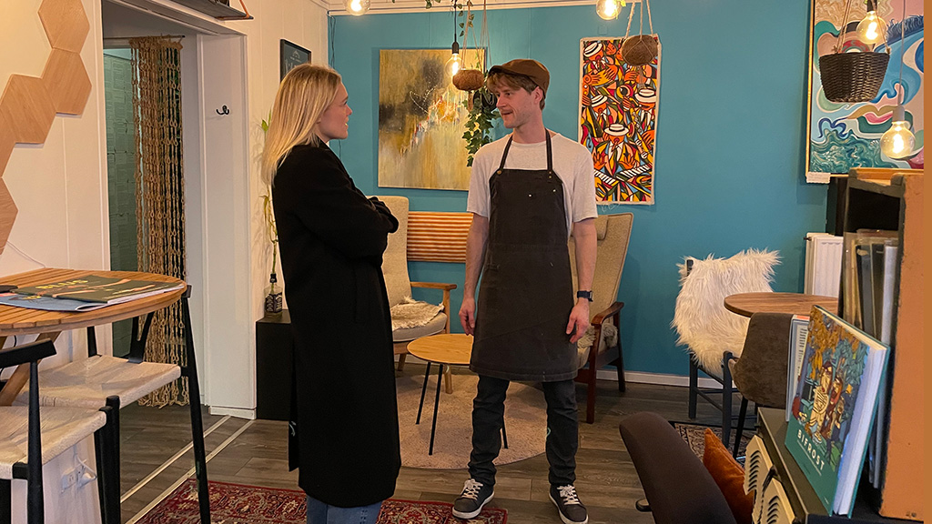 The owner chats with a guest at Café SNAK