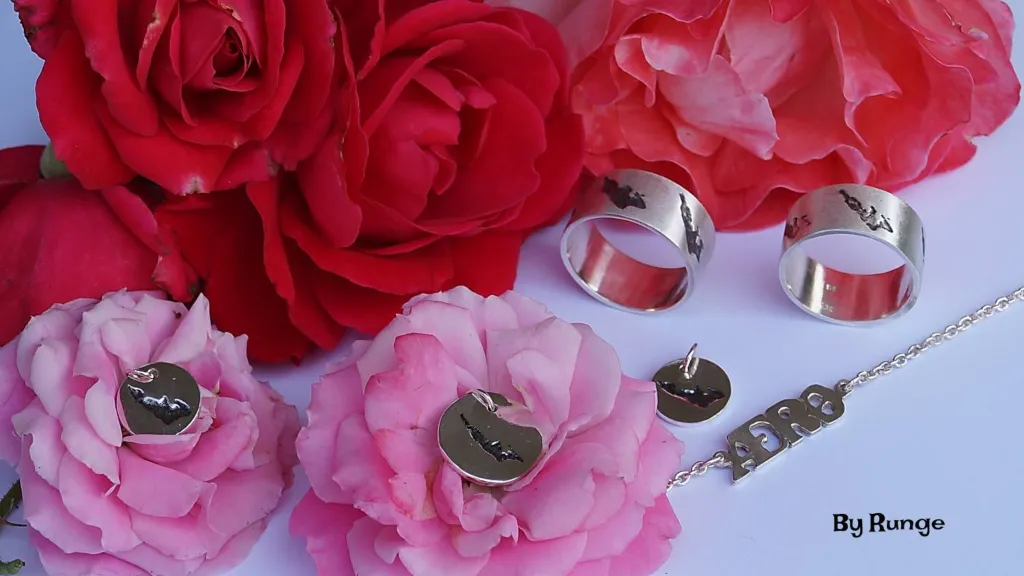 Unique jewelry in the form of rings on a bed of roses from By Runge