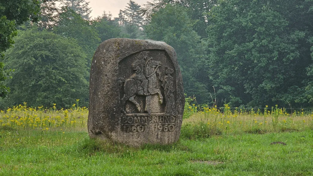Memorial stone with a motive of a man riding a horse