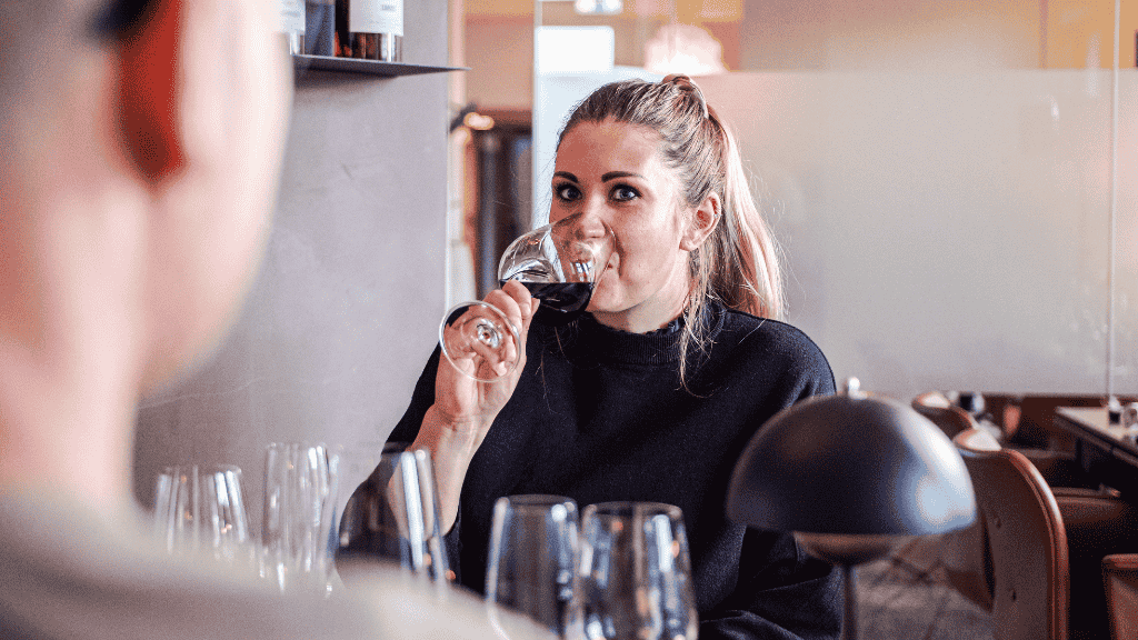 Woman drinks a glass of wine at Restaurant No. 10