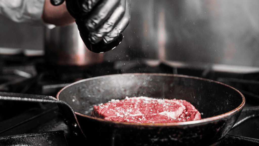 The steak is seasoned with salt in the pan at Restaurant No. 10.